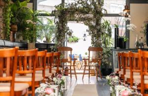 a room with chairs and an arch with flowers at The Captain Cook in London