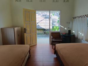Postel nebo postele na pokoji v ubytování Lombok Sunset Hideaway