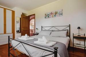 a bedroom with a bed with two towels on it at Entire apartment in villa with parking in Frascati