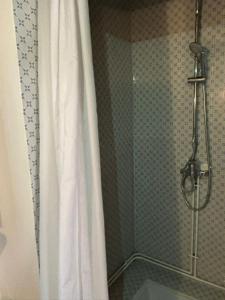 a shower with a shower curtain in a bathroom at Les Côtières in Maresville +1 photo