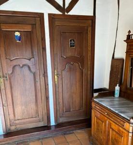two wooden doors in a kitchen with a counter at Les Côtières in Maresville