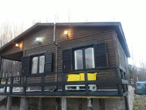 a large wooden house with windows on a platform at Cabaña Terra Nostra in Potrerillos