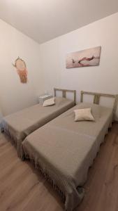 two beds sitting next to each other in a room at Chez Pascaline in Nyons +46 photos