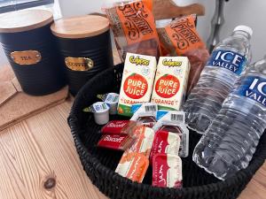 a basket filled with snacks and water bottles at The Borough Apartment in Kent