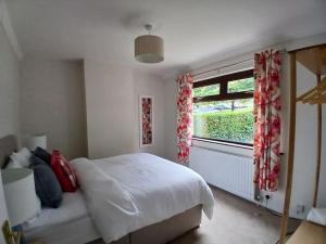 a bedroom with a white bed and a window at Vine inn in Banbridge