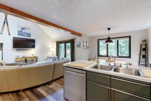a kitchen with a sink and a couch at Cozy Condo In The Woods in Lincoln +16 photos