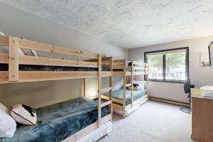 two bunk beds in a room with a window at Cozy Condo In The Woods in Lincoln
