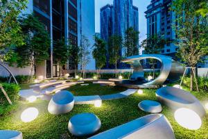 a park with blue and white benches and buildings at Scarletz suites klcc Bukit Bintang by lulu in Kuala Lumpur
