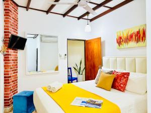 a bedroom with a bed with a yellow blanket at The Backpack by Dorset in Negombo