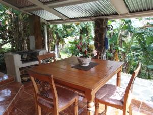 a wooden table with chairs and a potted plant on it at Luxury appartmant in Altos del Maria with Аuthors breakfast in Sorá