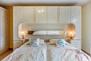 a bedroom with a large white bed with two pillows at Haus Landblick in Zell im Wiesental +15 photos