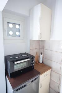 a kitchen with a toaster oven on a counter at Apartment Lea in Belgrade +9 photos