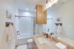 a bathroom with a sink and a tub and a toilet at Lake Palestine Vacation Rental - Steps to Water! in Coffee City +28 photos
