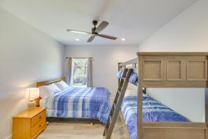 a bedroom with two bunk beds and a ceiling fan at Lake Palestine Vacation Rental - Steps to Water! in Coffee City