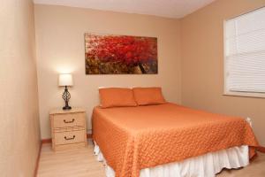 a bedroom with a bed and a painting on the wall at 3 Bedrooms 2 Baths Pool Home available for LONGER STAYS!!! in Port Saint Lucie +30 photos