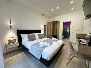 a bedroom with a large bed with towels on it at Good Vibes Luxury Rooms in Agerola
