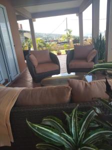 a living room with two chairs and a couch at ChezRoselineetChritian in Les Avirons