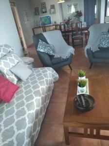 a living room with a couch and a coffee table at ChezRoselineetChritian in Les Avirons +10 photos