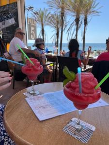 two cocktails sitting on a table at a restaurant at Apartment Silica near Bonzana Square in Benalmadena Costa