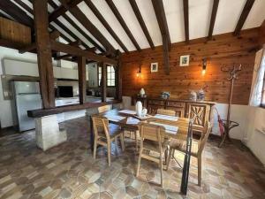 a dining room with a table and chairs at La bergerie de lesbordes in Lestajaou