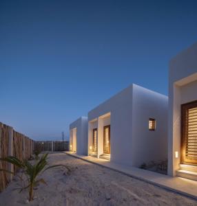 a white house on the beach at night at Nido 23 in San Benito