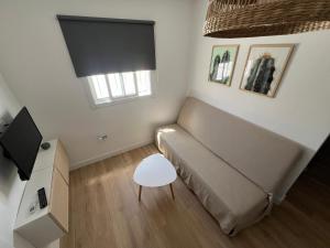 a small living room with a couch and a tv at Casa Gabi in La Sabinita