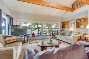 a living room with a couch and a table at Waterfront Getaway on Sodus Bay Prime Location! in North Rose