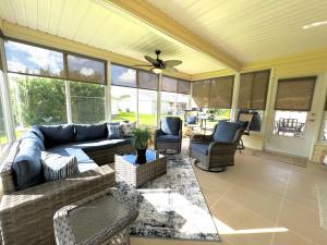 a large living room with a couch and chairs at Delia Place Sunny Florida Lanai Retreat in The Villages