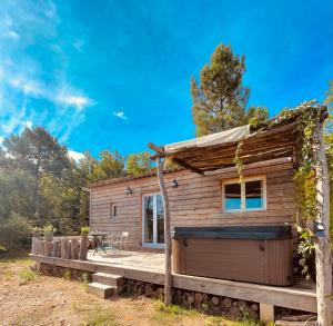 a log cabin with a porch and a deck at La cabane du Mas gnolia in Saint-Jean-du-Gard
