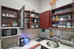 a kitchen with a sink and a microwave at Knights&Lords Apartment, Old Town in Kraków