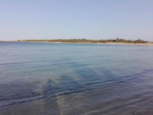 a large body of water with trees in the distance at B & B La Magnolia in Specchiolla
