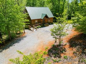 a cabin in the woods with a gravel driveway at Foothills Family Retreat - 7 Bedrooms, Hot Tub in Cleveland