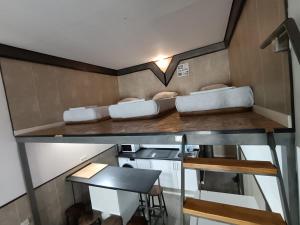 a small kitchen with two beds on a counter at Aparsol Apartments in Madrid