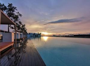 a large pool of water with a sunset in the background at Sutera Avenue - 6 Pax 2 Rooms - Opposite Imago Shopping Mall in Kampong Sembulan