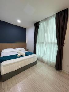 a bedroom with a bed and a large window at Sutera Avenue - 6 Pax 2 Rooms - Opposite Imago Shopping Mall in Kampong Sembulan +9 photos
