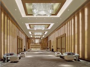 a large hallway with chairs and chandeliers in a building at Langham Place Guangzhou - Walking distance to Canton Fair in Guangzhou