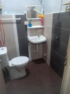 a small bathroom with a toilet and a sink at Reisya Homestay in Kepala Batas