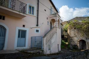 a white building with a blue door and stairs at La Casa di Fedora in Capestrano +13 photos