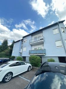 a white car parked in front of a building at WOW Urban Nest Saarbrücken in Scheidt +5 photos