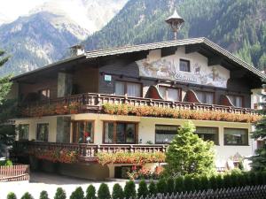 a building with flowers on the balconies of it at Hotel Sportpension Carinthia in Sölden