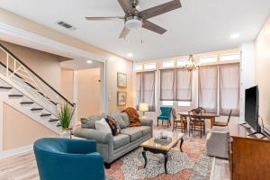 a living room with a couch and a tv at 610 Franklin - Downstairs - 2 Bed, 2 Bath, Heart of Downtown, Pet Friendly with fee in Natchez