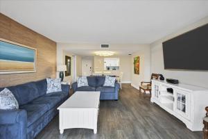 a living room with a couch and a tv at 6415 Midnight Pass #202 in Siesta Key