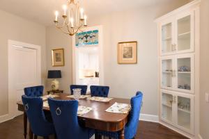 a dining room with a table and blue chairs at Borum House - 3 Bed, 2 & Half Bath, Full Kitchen, Heart of Downtown Natchez in Natchez