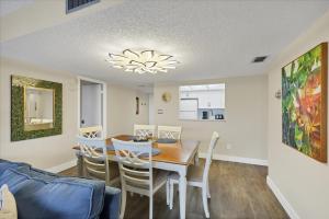a dining room and kitchen with a table and chairs at 6415 Midnight Pass #202 in Siesta Key