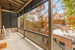 a screened in porch with a chair on it at 610 Franklin - 3 Bed, 3 Bath, Duplex, Heart of Downtown in Natchez