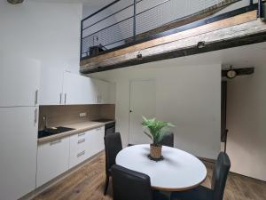 a kitchen with a table and chairs in a room at La casa Bosch in Sombernon