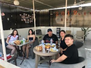 a group of people sitting at tables in a restaurant at golden mask pyramids view in Cairo +32 photos