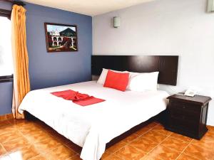 Postel nebo postele na pokoji v ubytování Hotel Jardines Del Carmen