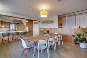a large kitchen with a wooden table and chairs at Red Hawk Coastal Estate in San Diego