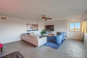 a living room with a couch and a ceiling fan at Red Hawk Coastal Estate in San Diego